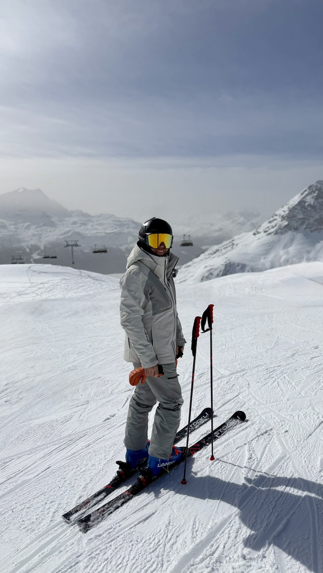 Adam on the mountain with his ski equipment