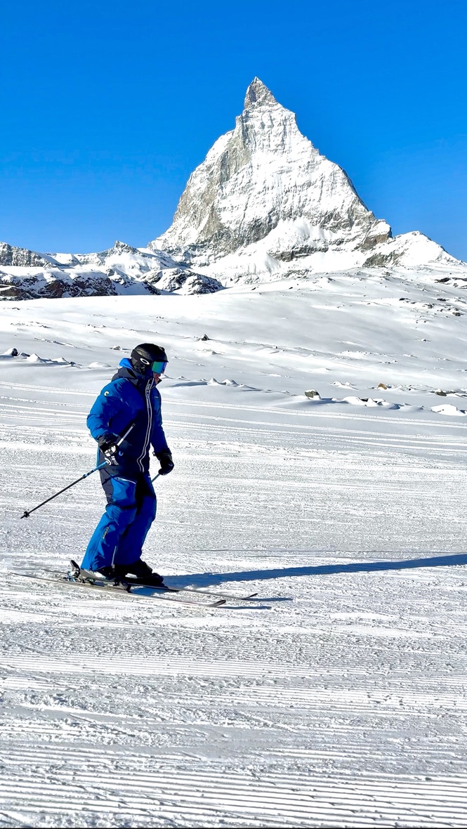Adam skiing in his blue CarveSport suit beneath the Matterhorn in Zermatt