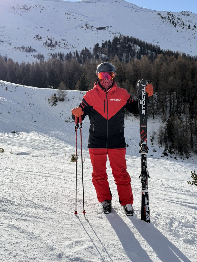 Adam on the mountain with his skiing equipment